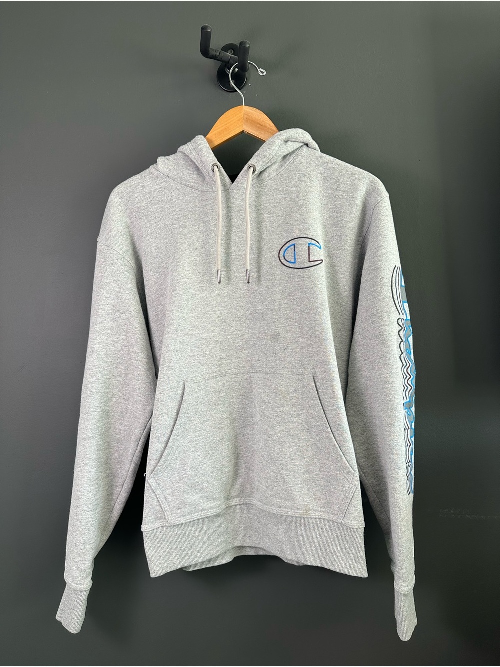 Champion Light Gray Hoodie with Blue Logo and Sleeve Graphic